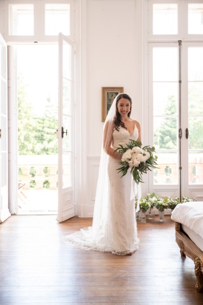 Bride holding bouquet of flowers in room